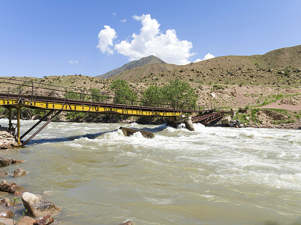 Old, partly damaged bridge. Valley of river Suusamyr in the Tien Shan Mountains. Asia, central Asia, Kyrgyzstan