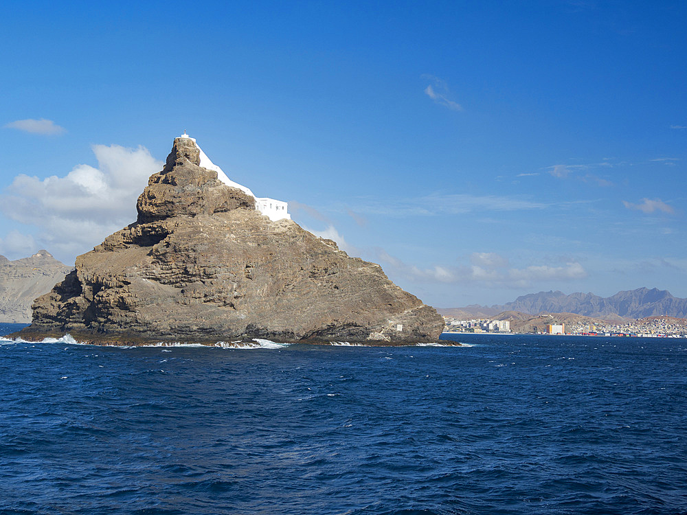 Lighthouse on Ilheu dos Passaros (bird island) at the port entrance. City Mindelo, a seaport on the island Sao Vicente, Cape Verde in the equatorial atlantic. Africa, April