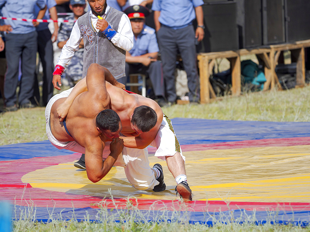 Kuresh, traditional Kyrgyz wrestling. Folk and Sport festival on the Suusamyr plain commemorating Mr Koshomkul, a sportsman and folk hero of the last century. Asia, central Asia, Kyrgyzstan