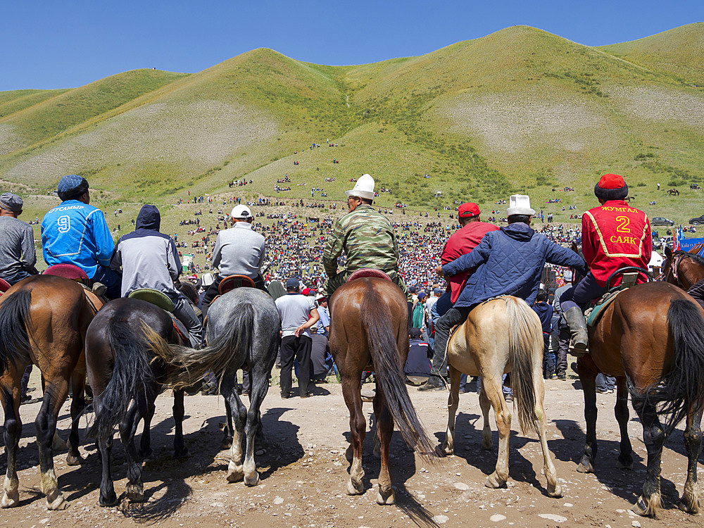 Visitor on horse. Folk and Sport festival on the Suusamyr plain commemorating Mr Koshomkul, a sportsman and folk hero of the last century. Asia, central asia, Kyrgyzstan