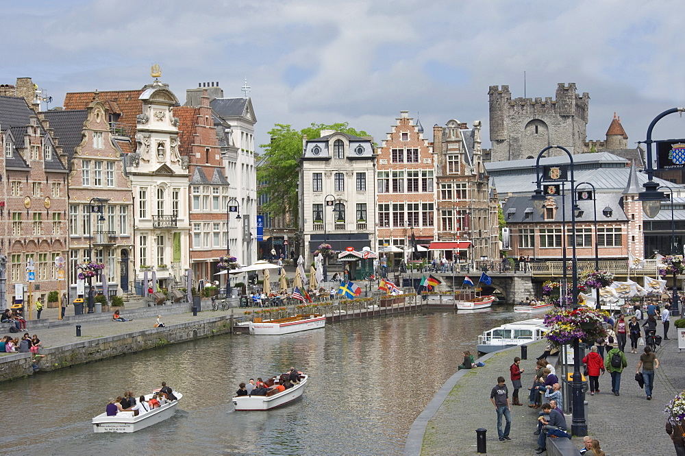 Everyday scene along the Graslei bank, lined with Baroque style Flemish gabled houses, Gravensteen Castle beyond, in the centre of Ghent, Belgium, Europe