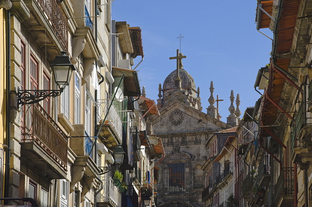 A church dominates a narrow street in the old town, Oporto, Portugal, Europe