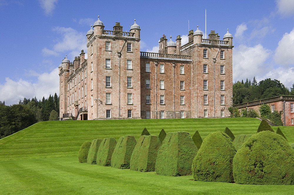 The 17th century Renaissance Drumlanrig Castle (Pink Palace) built by the 1st Duke of Queensberry William Douglass, viewed from the topiary garden, overlooking the Nith Valley, Dumfries and Galloway, Scotland, United Kingdom, Europe