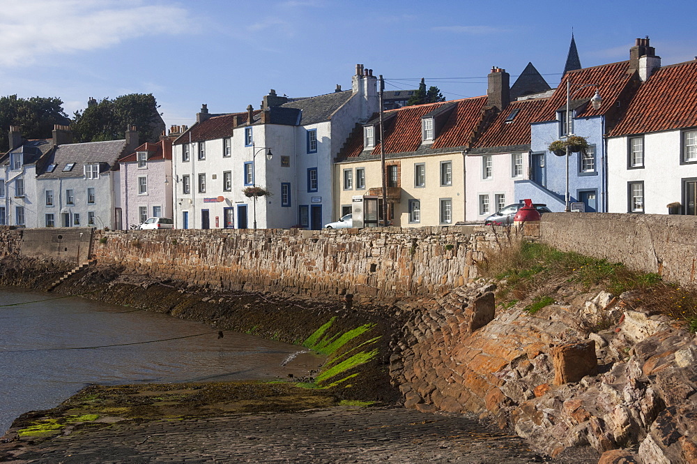 Harbour wall, low tide and pastel coloured cottages, St. Monan, East Coast, Fife, Scotland, United Kingdom, Europe 