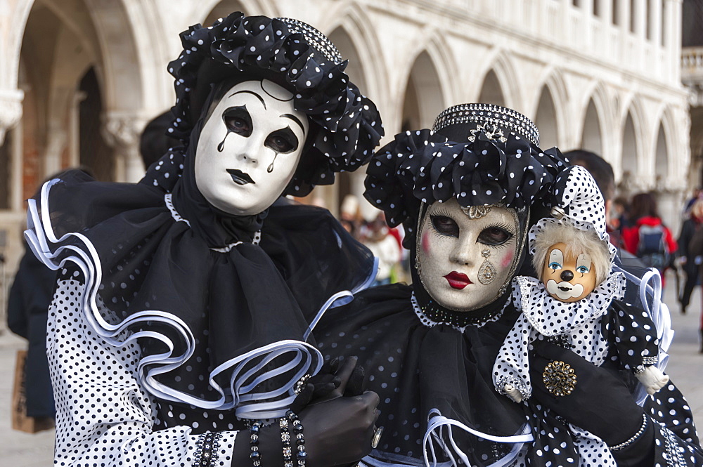 Couple in black and white with clown puppet, Venice Carnival, Venice, Veneto, Italy, Europe