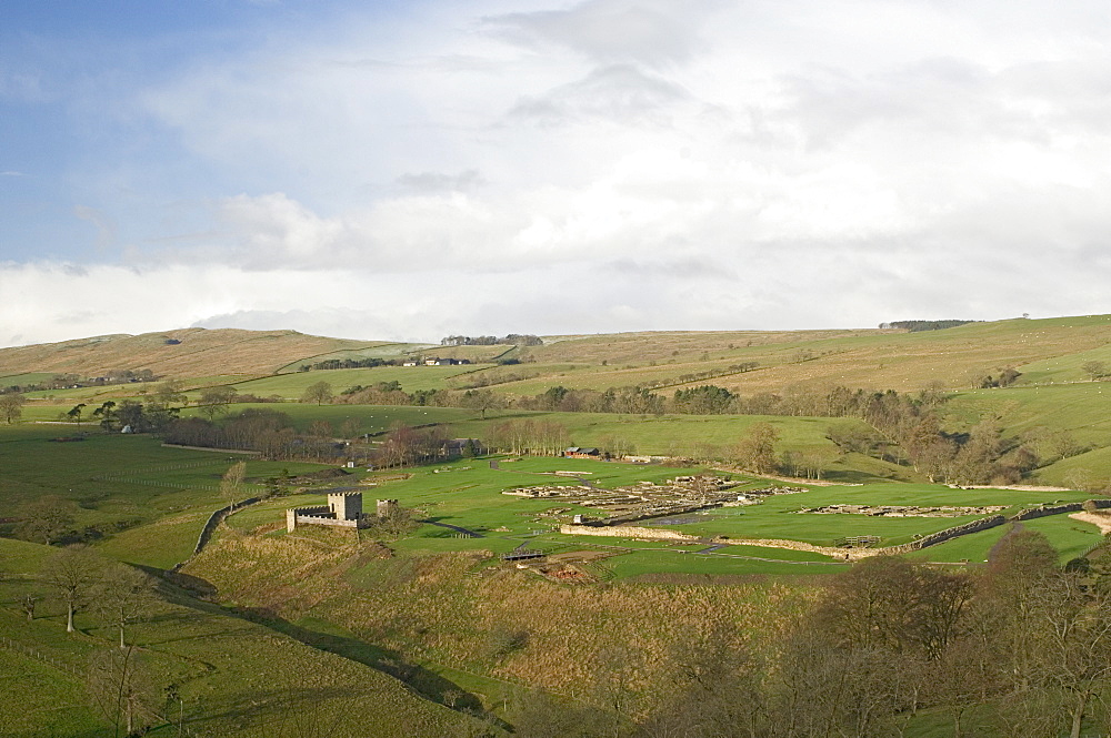 Looking west over Roman settlement and fort, Vindolanda, with the Roman Wall on the skyline, UNESCO World Heritage Site, Northumbria, England, United Kingdom, Europe