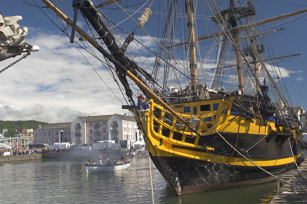 Tall ship Grand Turk, moored in inner harbour, with long boat in attendance, Whitehaven. Cumbria, England, United Kingdom, Europe