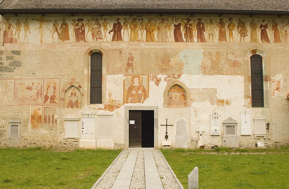 Extensive fresco treatment of the exterior of the ancient church of Chiesa di Vigilio, Pinzolo, Trentino-Alto Adige, Italy, Europe