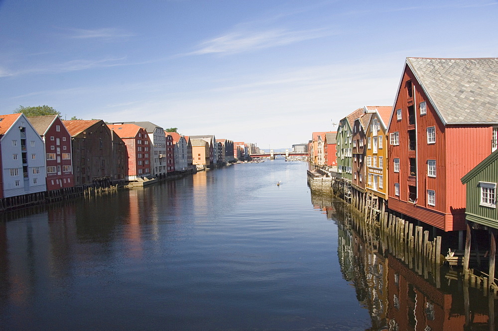 The Nidelva with merchants warehouses each side leading to the old dock area, Trondheim, Norway, Scandinavia, Europe