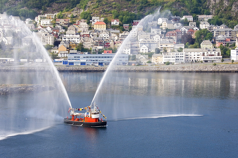 Dressed overall, with the traditional farewell display, the fireboat at Alesund, Norway, Scandinavia, Europe