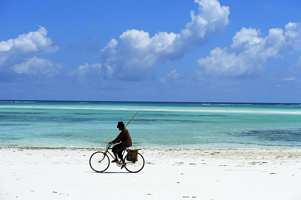 A man riding his bicycle of Kiwengwa beach, island of Zanzibar, Tanzania, East Africa, Africa