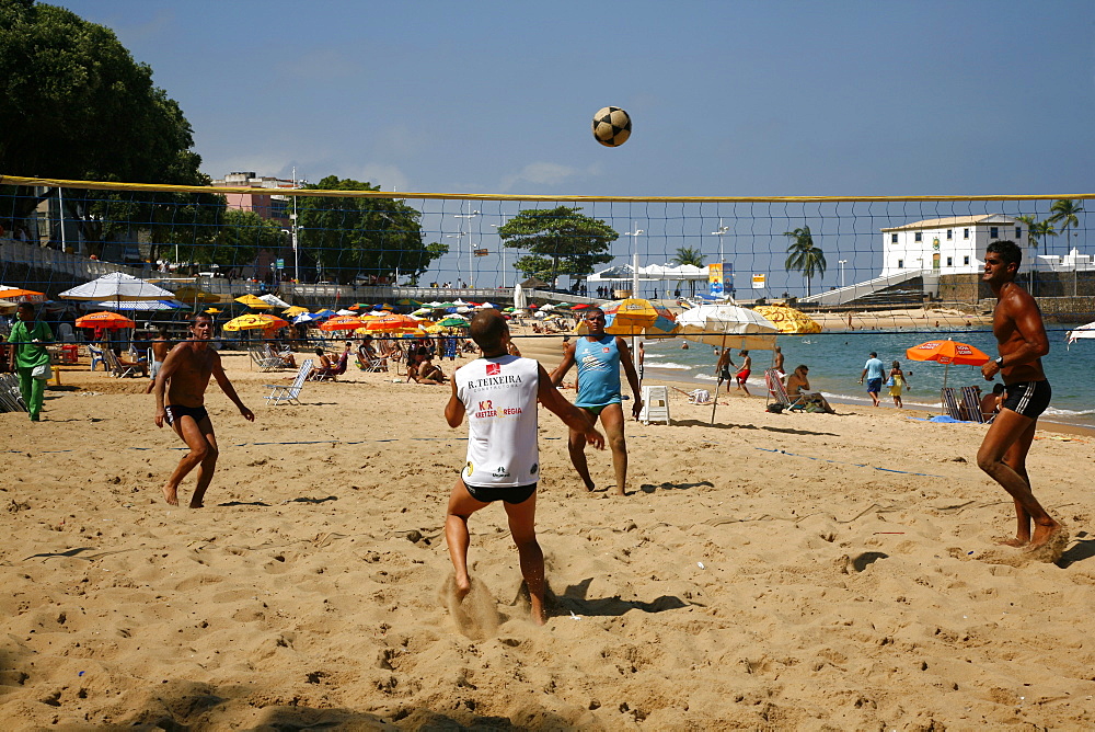 Men playing foot volleyball at Porto da Barra beach, Salvador (Salvador de Bahia), Bahia, Brazil, South America 