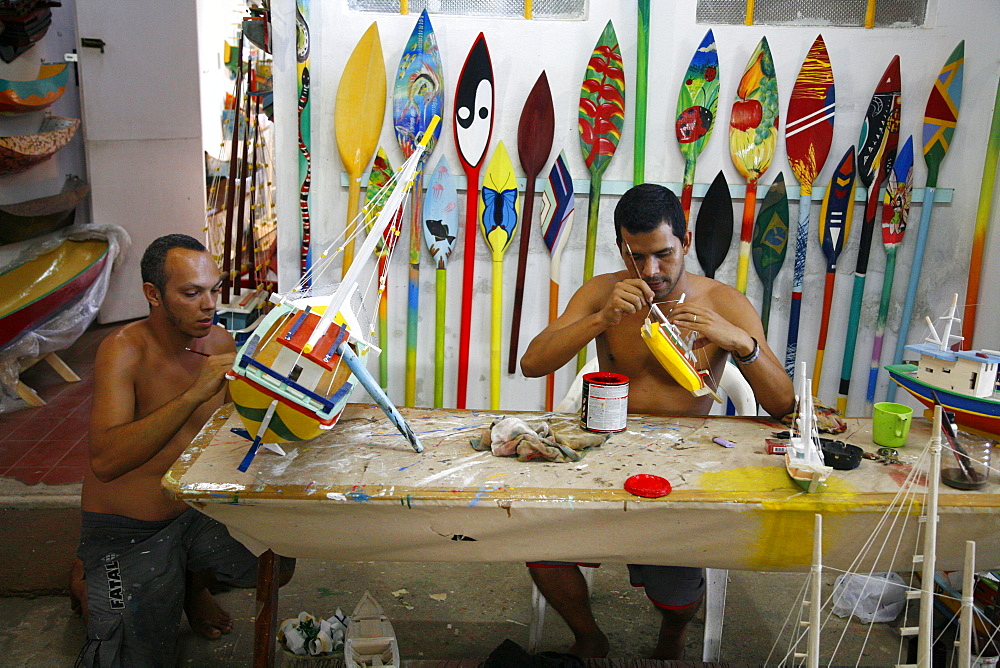 Artist at a local workshop making wooden boats as souvenirs, Paraty (Parati), Rio de Janeiro State, Brazil, South America