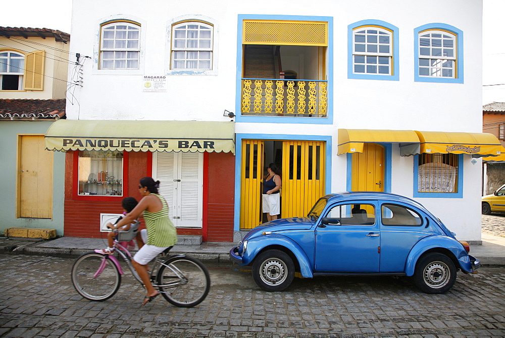 People riding a bicycle, Paraty (Parati), Rio de Janeiro State, Brazil, South America