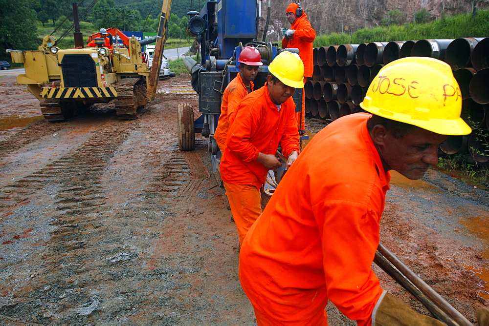 Workers putting pipes for natural gas near Congonhas, Minas Gerais, Brazil, South America