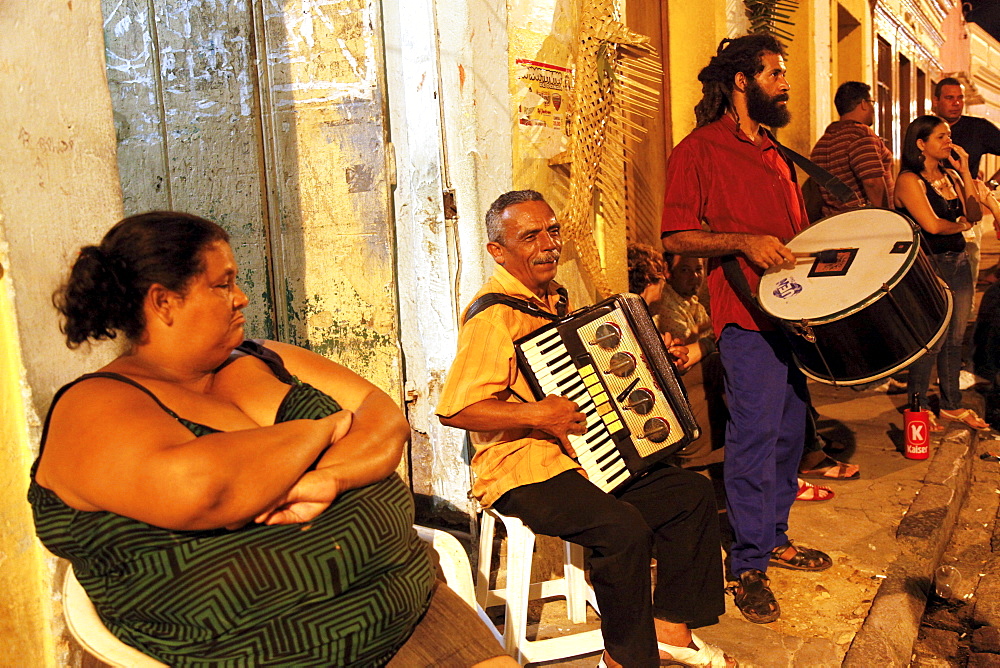 People playing music on the street at night in Olinda, Pernambuco, Brazil, South America