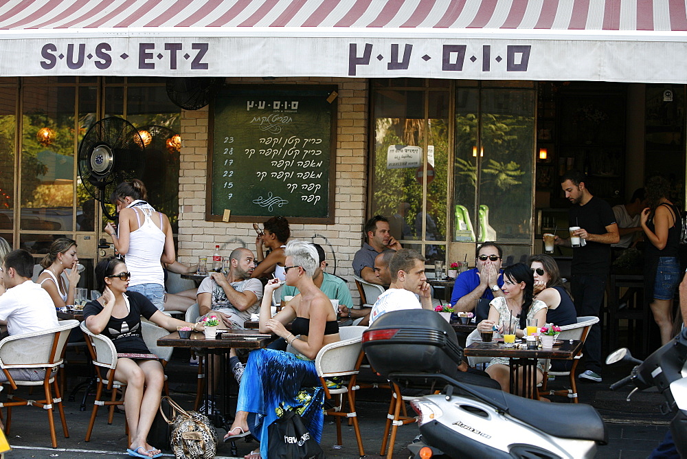 Young people sitting at Sus Etz Cafe in the trendy Sheinkin street, Tel Aviv, Israel, Middle East