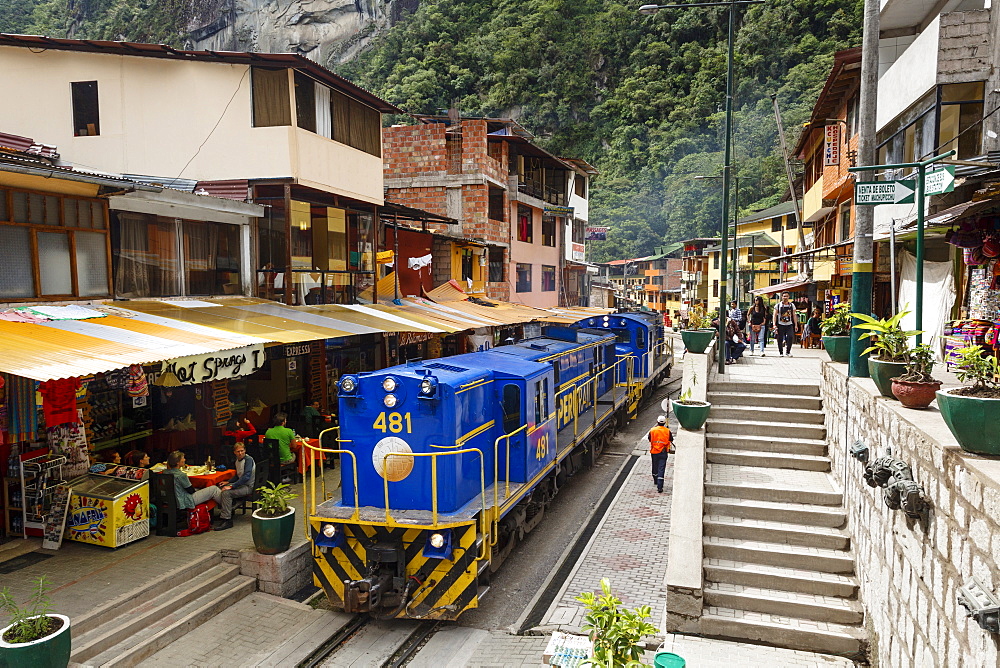 Train crossing the town of Aguas Calientes, Peru, South America