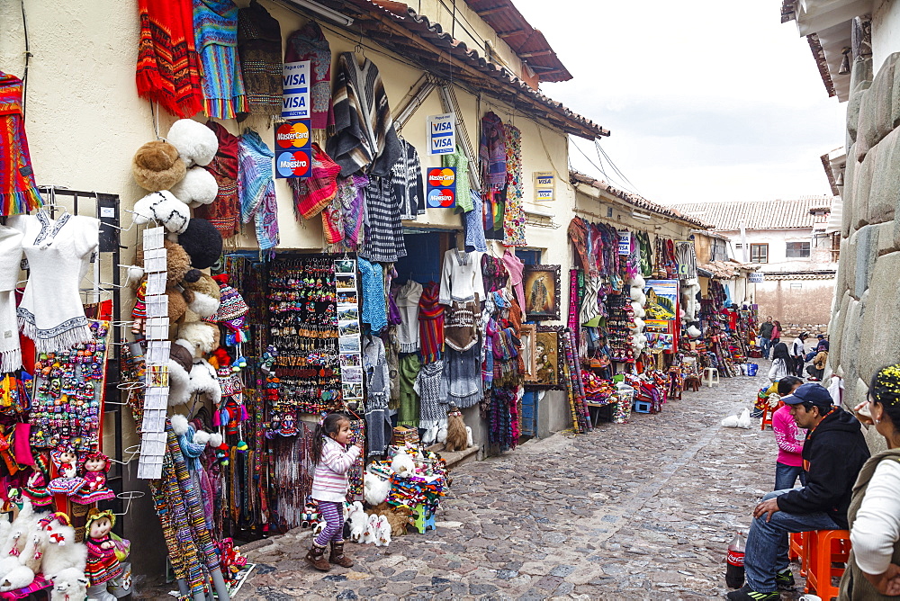 Shops along the the Inca wall at Hathunrumiyoq Street, las piedras del los 12 angulos (the stone of the 12 angles), Cuzco, Peru, South America