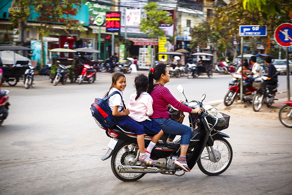 Mother and daughters riding a scooter, Siem Reap, Cambodia, Indochina, Southeast Asia, Asia