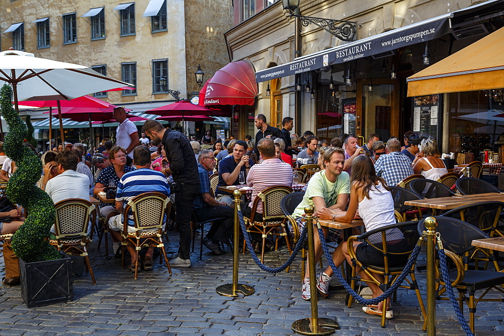 People sitting at a restaurant in Jarntorget square in Gamla Stan, Stockholm, Sweden, Scandinavia, Europe