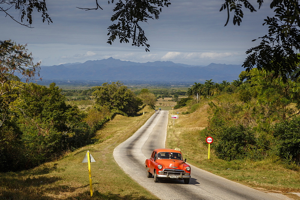 Old vintage American car on a road outside Trinidad, Sancti Spiritus Province, Cuba, West Indies, Caribbean, Central America