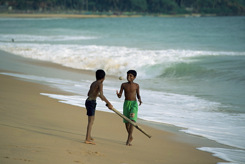 Boys playing cricket, Hikkaduwa beach, Sri Lanka, Asia