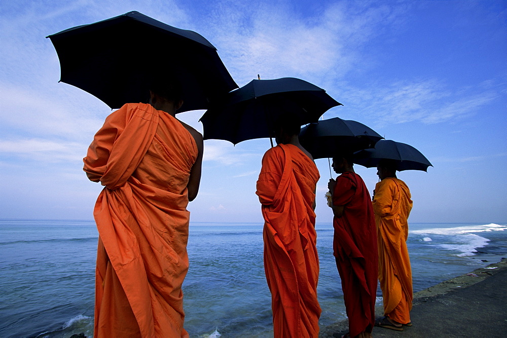 Buddhist monks watching the Indian Ocean, Colombo, island of Sri Lanka, Asia