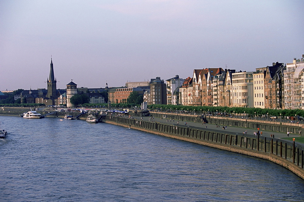 View over the Rheinuferpromenade along River Rhine and the old city with Lambertus church castle tower, Dusseldorf, North Rhine Westphalia (Nordrhein Westfalen), Germany, Europe