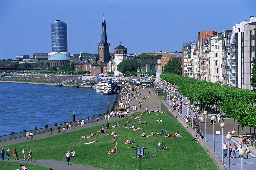 View over the Rheinuferpromenade along River Rhine and the old city with Lambertus church castle tower, Dusseldorf, North Rhine Westphalia (Nordrhein Westfalen), Germany, Europe