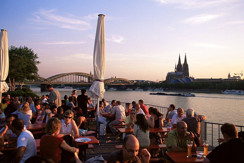 People sitting at the trendy Rheinterrassen bar and restaurant on the River Rhine, Cologne, North Rhine Westphalia, Germany, Europe