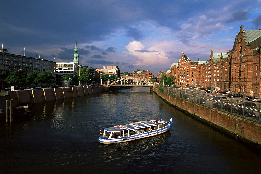 Excursion boat on canal in the Speicherstadt, the historical warehouse city area, Hamburg, Germany, Europe