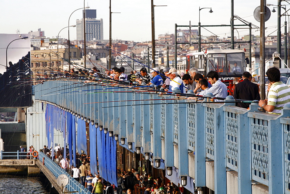 Fishermen standing on the Galata bridge, Istanbul, Turkey, Europe