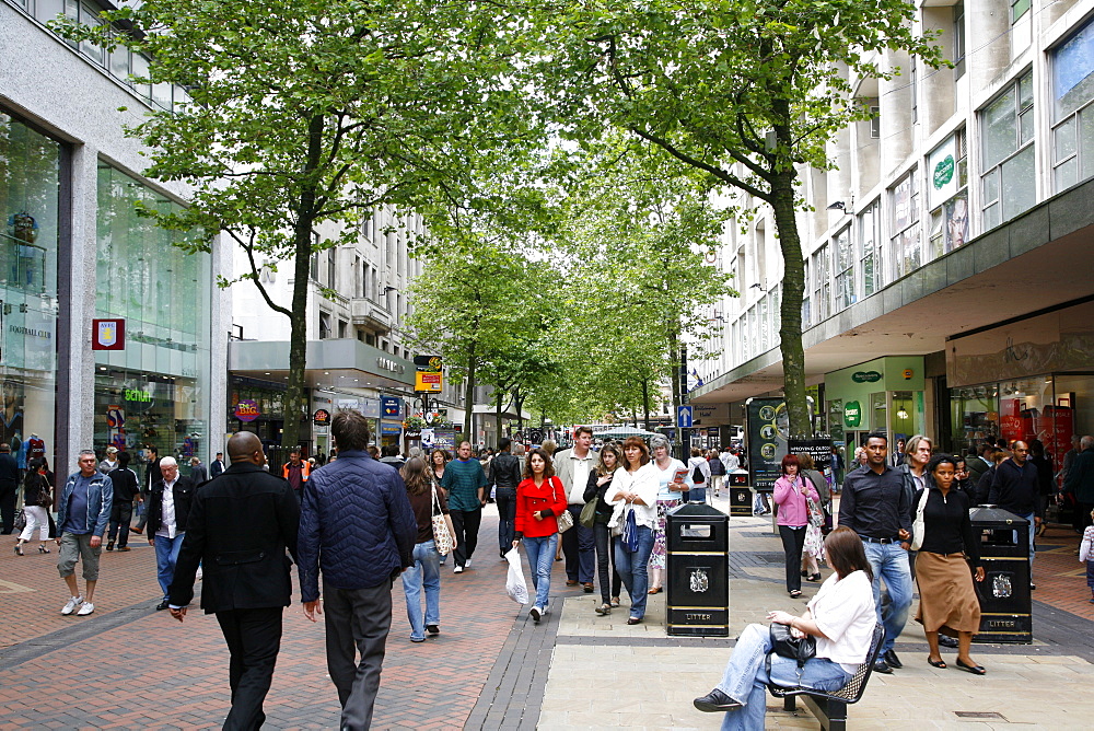 People walking down New Street, a pedestrian street with many shops. Birmingham, England, United Kingdom, Europe