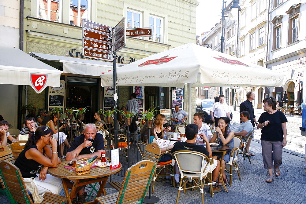 People sitting at an outdoor cafe in Malostranske Namesti Square, Mala Strana, Prague, Czech Republic, Europe