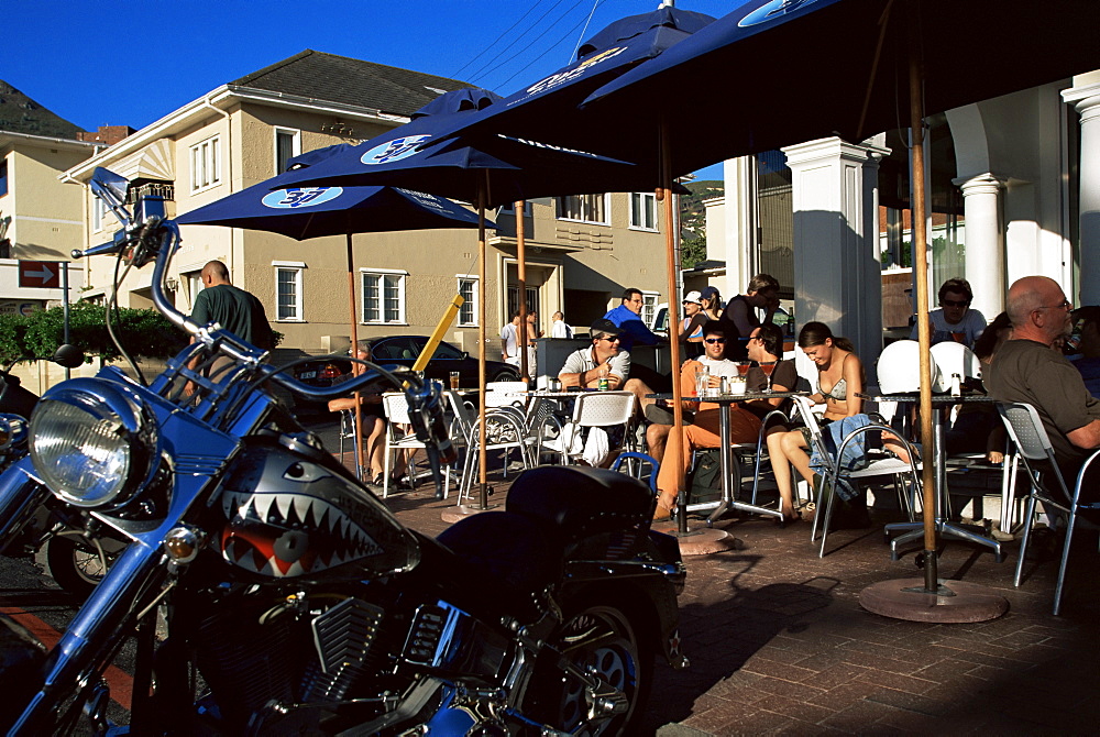 People sitting in trendy sidewalk cafe in Camps Bay, Cape Town, South Africa, Africa