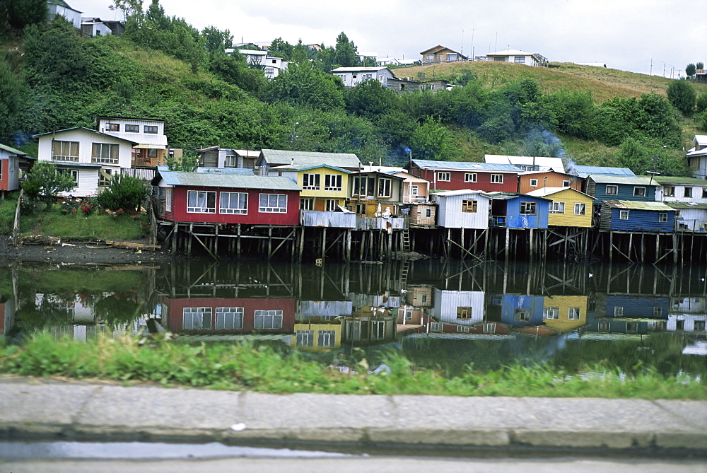 Houses on stilts reflected in the water, Palafitos, Castro, Chiloe Island, Chile, South America