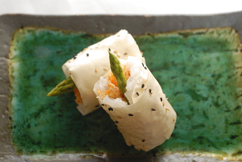 Sushi appetizer of salmon and asparagas in rice and sesame parcel, Japan, Asia