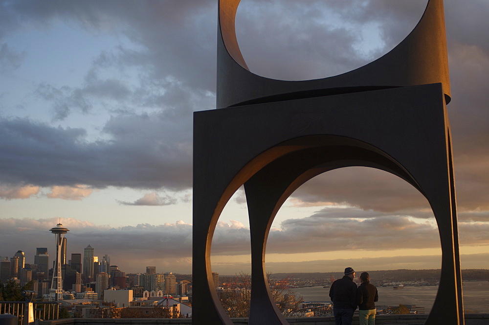 Couple framed with the Space Needle in the distance at Kerry Park, Seattle, Washington State, United States of America, North America