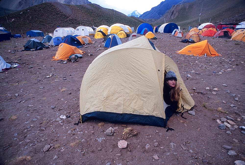 Woman wakes up at Confluencia Base Camp in Aconcagua National Park, Argentina, South America