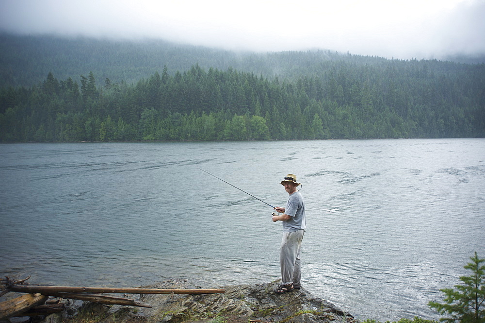 Man, 30 years old, fishes on Ross Lake, North Cascades National Park, Washington, United States of America, North America