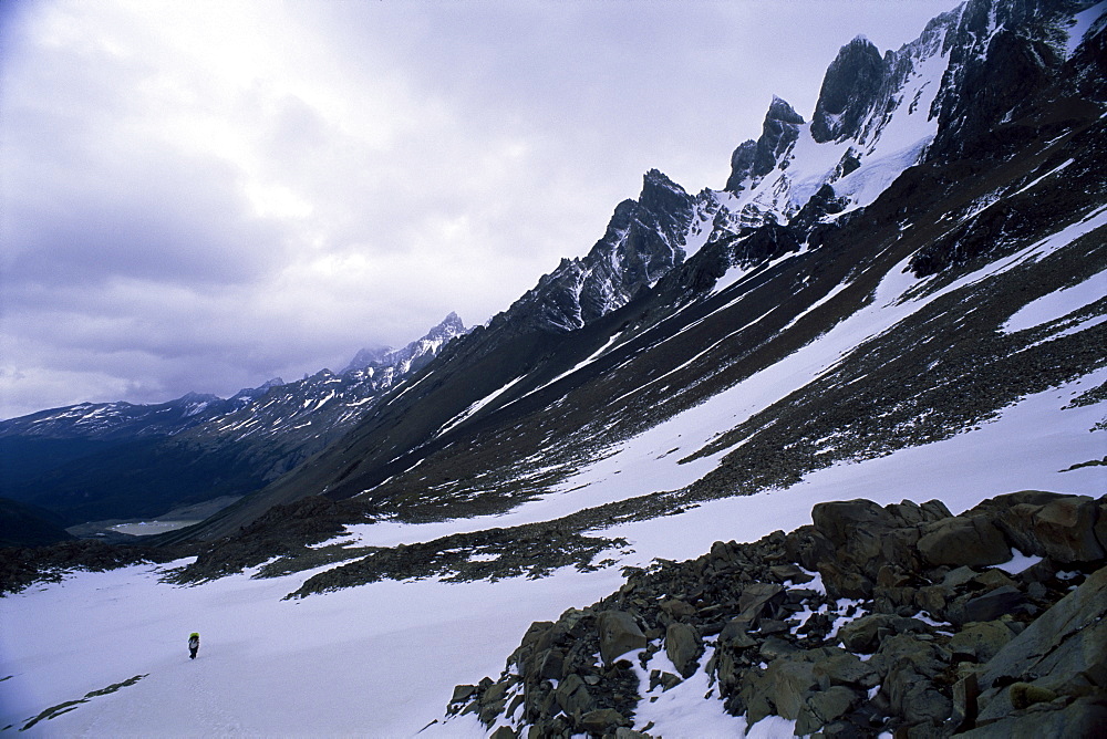 Backpacker climbing pass to get to Glacier Grey, in the Torres Circuit, Torres del Paine National Park, Chile, South America