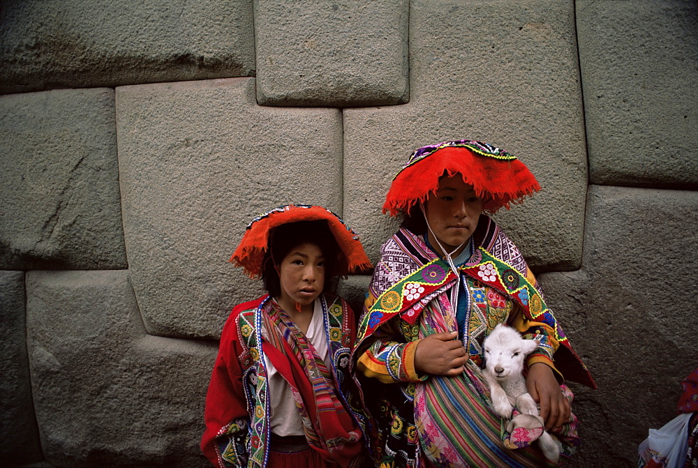 Girls pose for photograph in local dress, Cuzco, Peru, South America