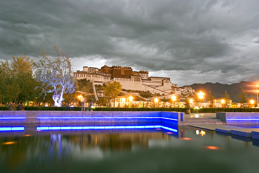 Water feature in front of the Potala Square lit up with neon blue lights in early evening, Lhasa, Tibet, China, Asia