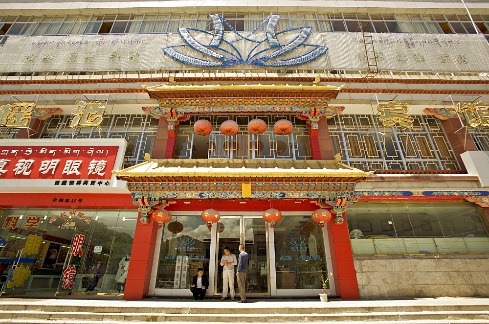 Modern shops line the Yutok Lam a street connecting the Jokhang temple to the Potala square, Lhasa, Tibet, China, Asia