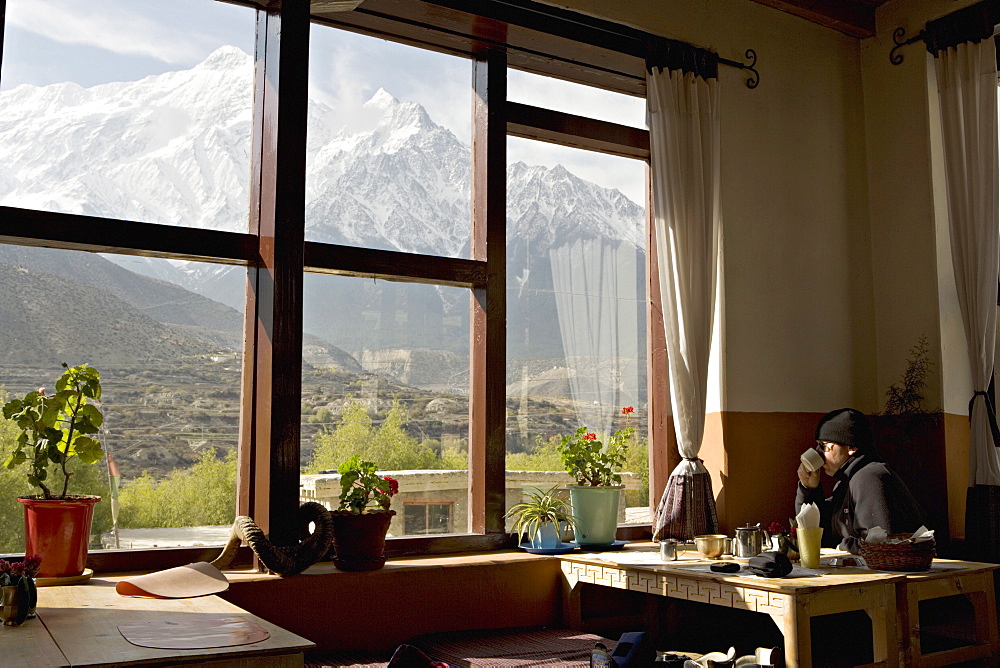 View of the Nilgiri range whilst enjoying breakfast in Om's Home hotel at Jomsom on the Annapurna circuit trek, Himalayas, Nepal, Asia