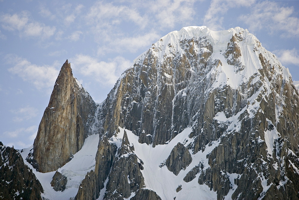 On the left the granite spire known as Lady Finger peak, or Bubulimating, summit 6,000m, high above Karimabad in the Karakoram mountains of the Northern Areas, Pakistan. On the right, Ultar Peak, 7388m and 73rd highest mountain in the world.