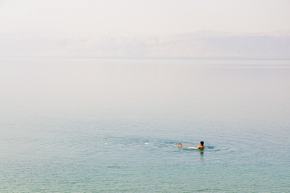 Man swimming in the Dead Sea, Jordan, Middle East