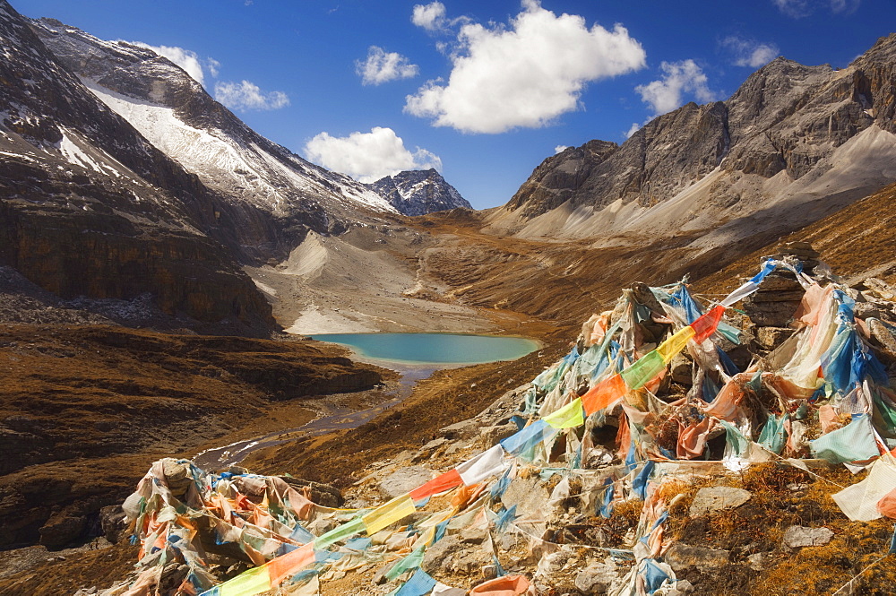 Prayer flags and Erongcuo Lake, Yading Nature Reserve, Sichuan Province, China, Asia