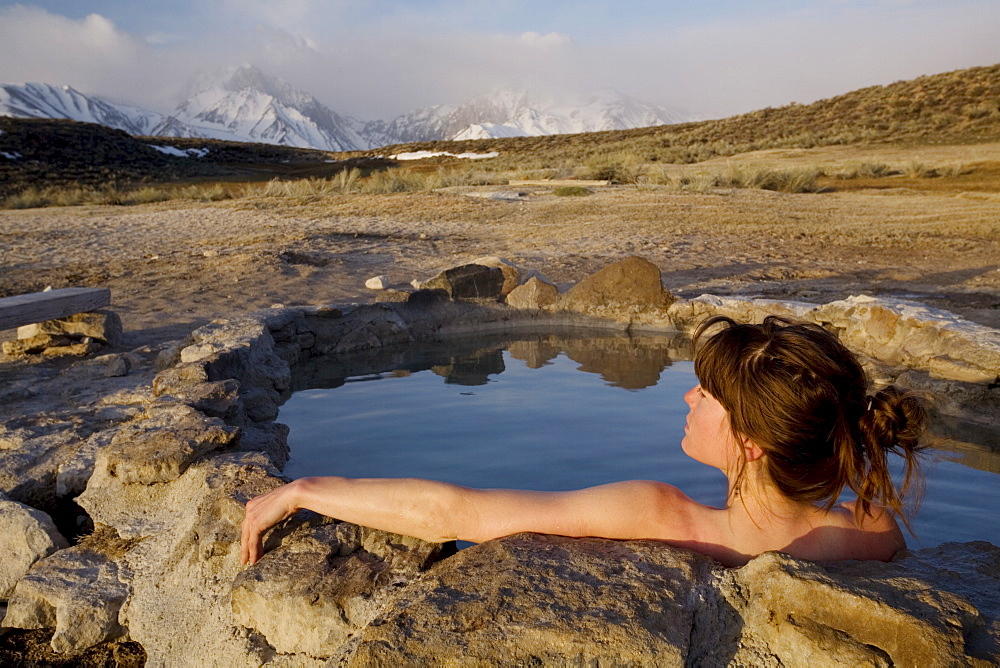 Woman relaxing in hot spring, Mammoth Lakes region, California, United States of America, North America